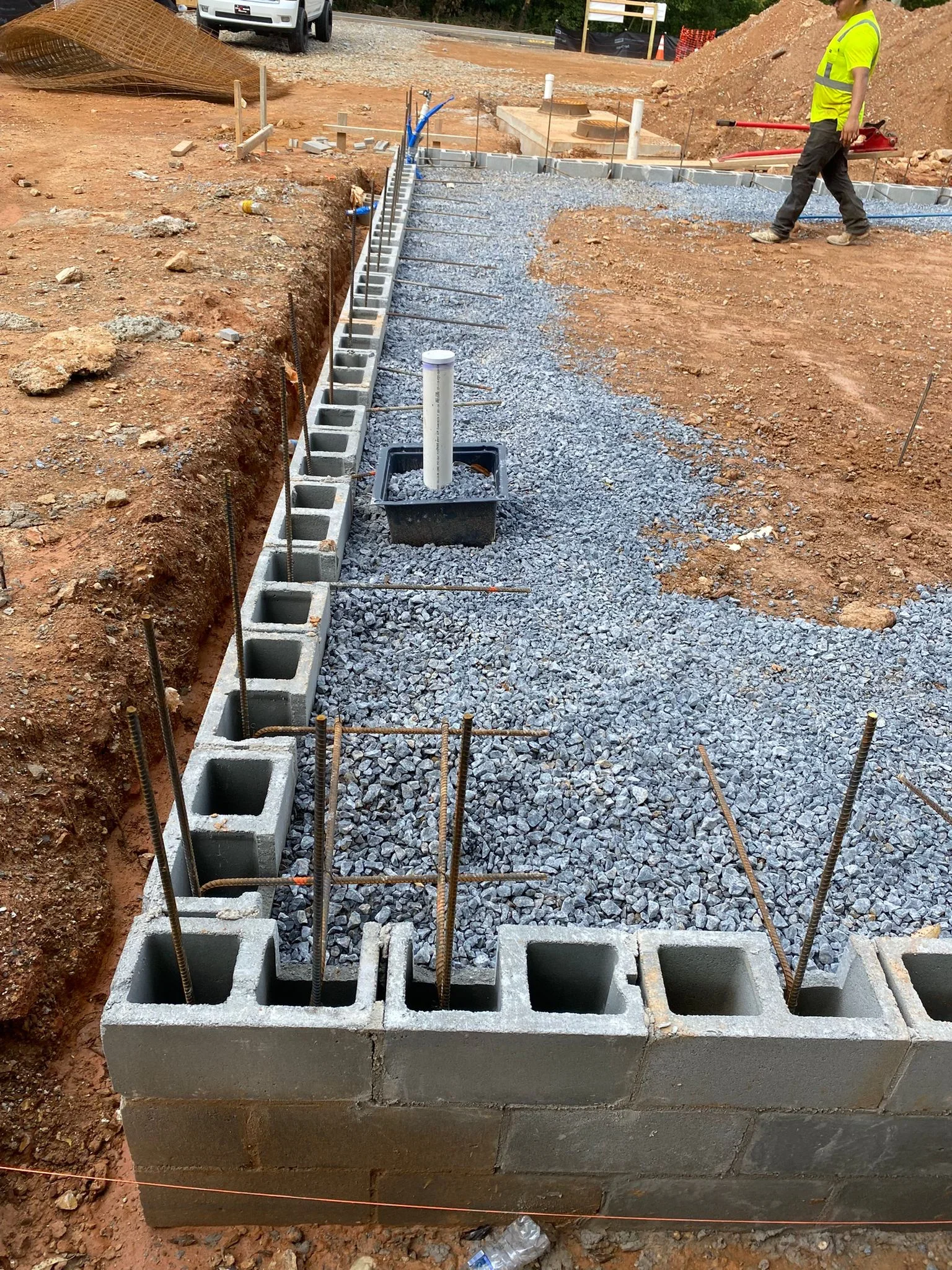 Concrete block foundation with drainage system and gravel base on construction site